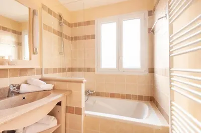 a bathroom with a tub and a sink and a window at Les Coteaux de Pont Royal en Provence - maeva Home - Maison 4 Pièces 8 Personnes - Sélection MAE-6026 in Mallemort