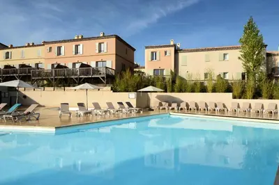 a swimming pool with chairs and a building at Les Coteaux de Pont Royal en Provence - maeva Home - Maison 3 Pièces 6 Personnes - Sélection MAE-8177 in Mallemort