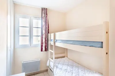 a bedroom with two bunk beds and a window at Les Coteaux de Pont Royal en Provence - maeva Home - Appartement 2 Pièces 6 Personnes - Sélection MAE-8180 in Mallemort