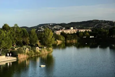a body of water with buildings in the background at Les Coteaux de Pont Royal en Provence - maeva Home - Appartement 4 pièces 7 personnes - Prestige - super Home MAE-2094 in Mallemort