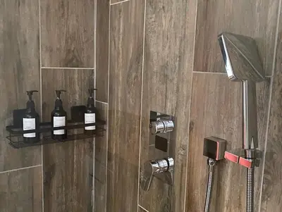 a bathroom with a shower with two bottles of soap at Instant Parfait en Provence Chambre privée et piscine in Monteux