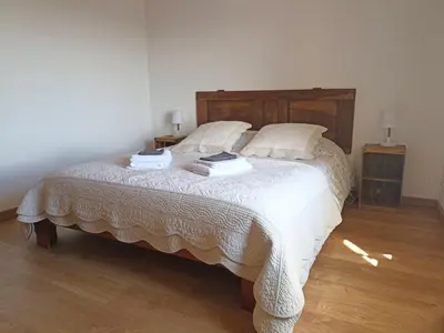 a bedroom with a bed with two books on it at Gite avec piscine 