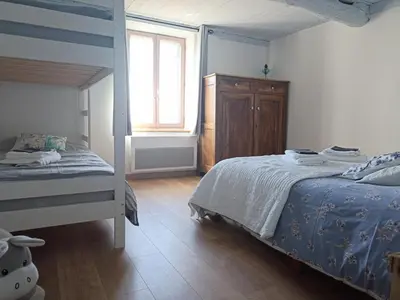 a bedroom with a bunk bed and a window at Gite avec piscine 