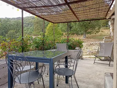 a blue table and chairs on a patio at Gite avec piscine 