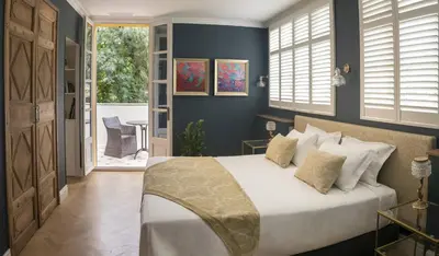 a bedroom with a large bed with blue walls at Villa Amara in Aix-en-Provence