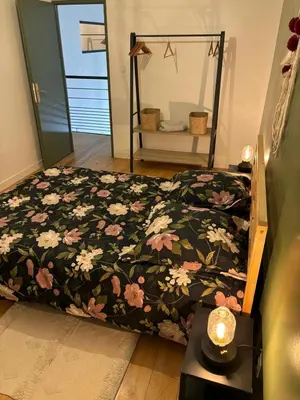 a bedroom with a bed with a floral comforter at Maison de charme avec piscine in Monteux