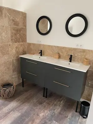 a bathroom with two sinks and two mirrors on the wall at Maison de charme avec piscine in Monteux