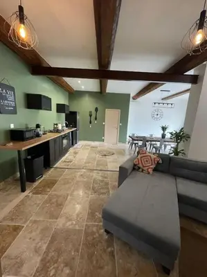 a large living room with a couch and a table at Maison de charme avec piscine in Monteux
