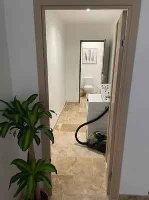 a hallway with a bathroom with a plant in a room at Maison de charme avec piscine in Monteux