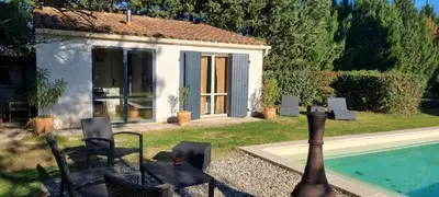 a small house with a swimming pool and a building at Les cabanons de l'Oliveraie in Pernes-les-Fontaines