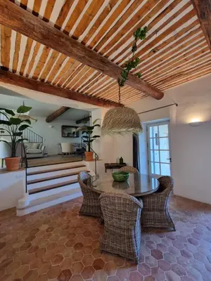 a dining room with a table and wicker chairs at Maison au centre du village de Gordes avec vue incroyable in Gordes