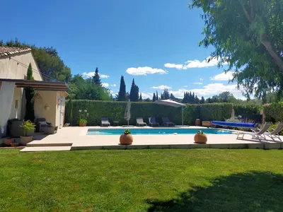 a backyard with a swimming pool and grass at Lou Mazet provençal à Eygalières - Piscine privée in Eygalières