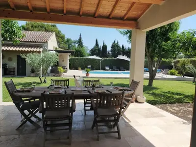 a dining table and chairs on a patio at Lou Mazet provençal à Eygalières - Piscine privée in Eygalières