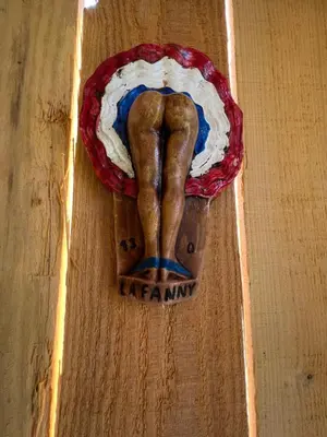 a wooden figurine of a leg on a wooden table at Cabanon bucolique face au Luberon in Lourmarin