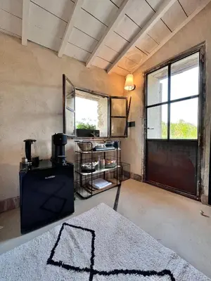 a room with a room with a table and a window at Cabanon bucolique face au Luberon in Lourmarin