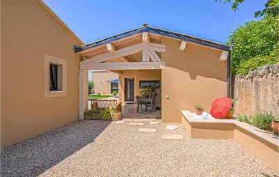 a home with a patio with a wooden pergola at Amazing Home In Robion in Robion en Luberon