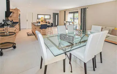 a dining room with a glass table and white chairs at Amazing Home In Robion in Robion en Luberon