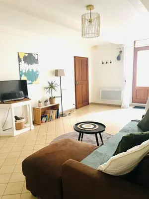 a living room with a couch and a table at Maison LINA in Sault-de-Vaucluse