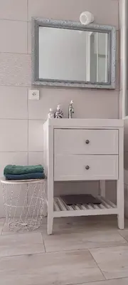 a white bathroom with a sink and a mirror at Maison LINA in Sault-de-Vaucluse