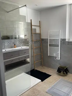 a bathroom with a glass shower and a sink at Gîte l’Inattendu in Vachères
