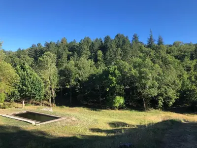 a large field with trees in the background at Logement calme avec vue sur le Luberon in Saignon