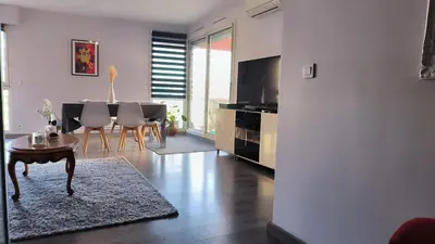 a living room with a table and a dining room at Appartement Port Royal in Aix-en-Provence