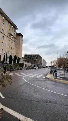 a park with trees and bushes in front of a building at Appartement Port Royal in Aix-en-Provence
