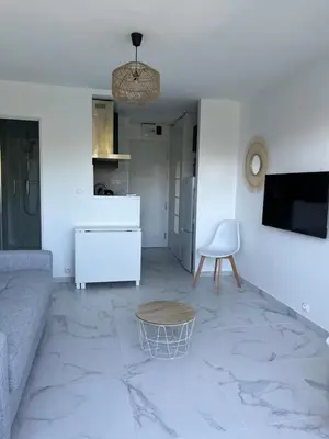 a living room with a couch and a table at Superbe appartement avec balcon et parking in Aix-en-Provence