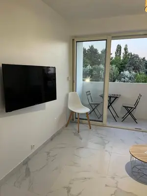 a living room with a flat screen tv on a wall at Superbe appartement avec balcon et parking in Aix-en-Provence