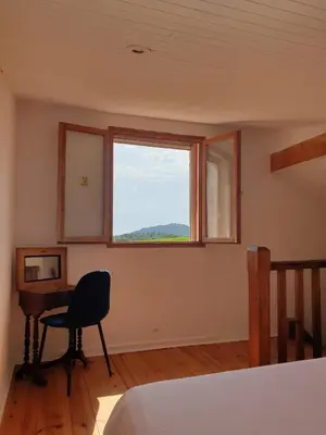 a bedroom with a desk and a window and a chair at Gite Les Robiniers in Beaumont-de-Pertuis