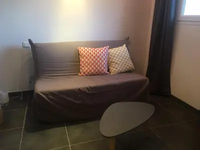 a bed with two pillows on it in a room at 2 pièces et mezzanine dès 2 nuits in Vedène