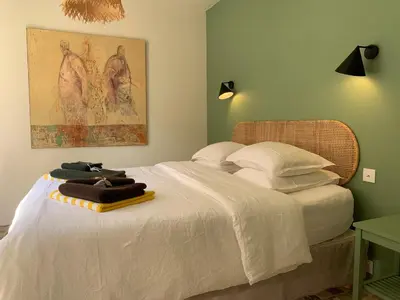 a bedroom with a bed with towels on it at Le Domaine de l'Aiguille Alpilles, Eygalières, Saint Rémy de Provence in Orgon