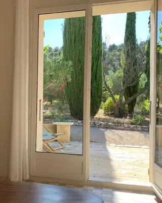 an open door with a view of a garden at Le Domaine de l'Aiguille Alpilles, Eygalières, Saint Rémy de Provence in Orgon