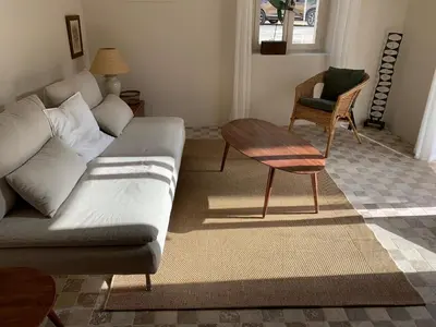 a living room with a couch and a table at Le Domaine de l'Aiguille Alpilles, Eygalières, Saint Rémy de Provence in Orgon