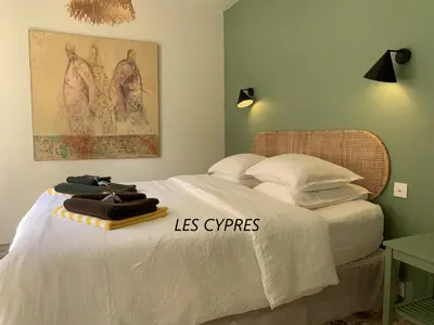 a bedroom with a white bed with towels on it at Le Domaine de l'Aiguille Alpilles, Eygalières, Saint Rémy de Provence in Orgon