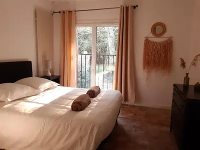 a room with two beds and a chair in it at La ferme du TourreBlanc in Lambesc
