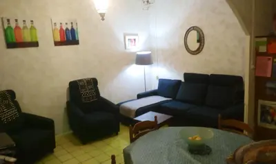 a living room with a couch and a table and chairs at Maison accueillante à Reillanne avec jardin clos in Reillanne
