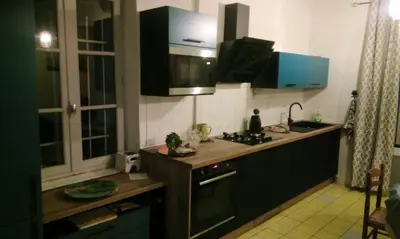 a kitchen with a sink and a stove top oven at Maison accueillante à Reillanne avec jardin clos in Reillanne
