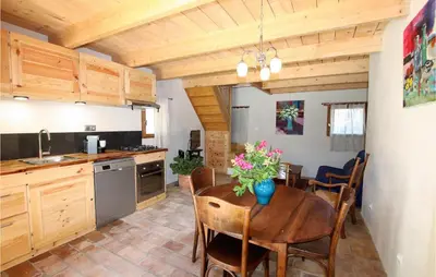 a kitchen and dining room with a table and chairs at 2 Bedroom Beautiful Home In St Didier in Saint-Didier