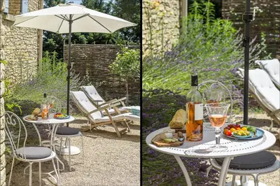 a table with a glass of wine and an umbrella at Le Mas de Caroline in Gargas