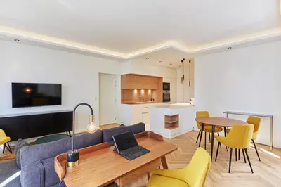 a living room with a couch and a table with a laptop at Appartement exceptionnel avec parking Centre-ville Aix-en-Provence in Aix-en-Provence