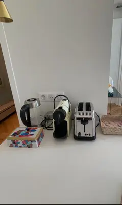 a kitchen counter with appliances sitting on the floor at Appartement exceptionnel avec parking Centre-ville Aix-en-Provence in Aix-en-Provence