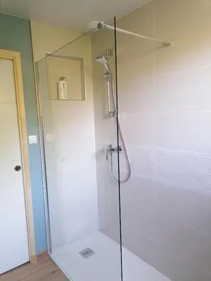 a shower with a glass door in a bathroom at Gîte Les Demoiselles des Sorgues in LʼIsle-sur-la-Sorgue