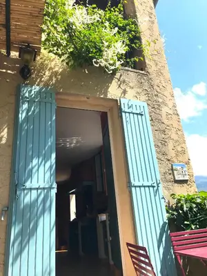 an entrance to a building with an open door at Au petit bonheur in Bédoin