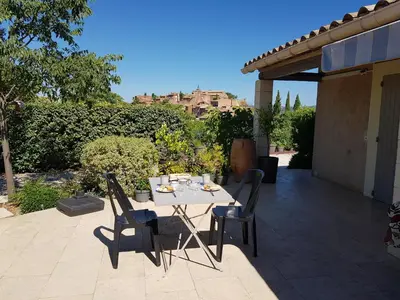 a table and chairs sitting on a patio at Chambre du sentier des ocres in Roussillon