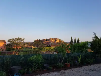 a view of a city from a garden at Chambre du sentier des ocres in Roussillon