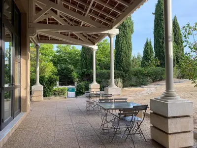 a large stone building with a large courtyard at Domaine de la Reynaude in Aurons