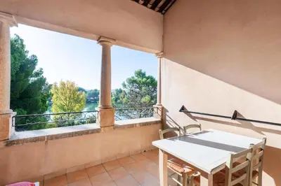 a balcony with a white table and a large window at Village Pont Royal en Provence - maeva Home - Appartement 2 pièces 5 personnes - Sélection MAE-8624 in Mallemort