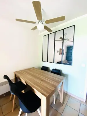 a dining room with a table and a ceiling fan at Village Pont Royal en Provence - maeva Home - Appartement 2 pièces 5 personnes - Sélection MAE-8624 in Mallemort