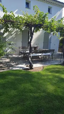 a picnic table and a bench in a yard at La Tour D'Orgueil in Mallemort
